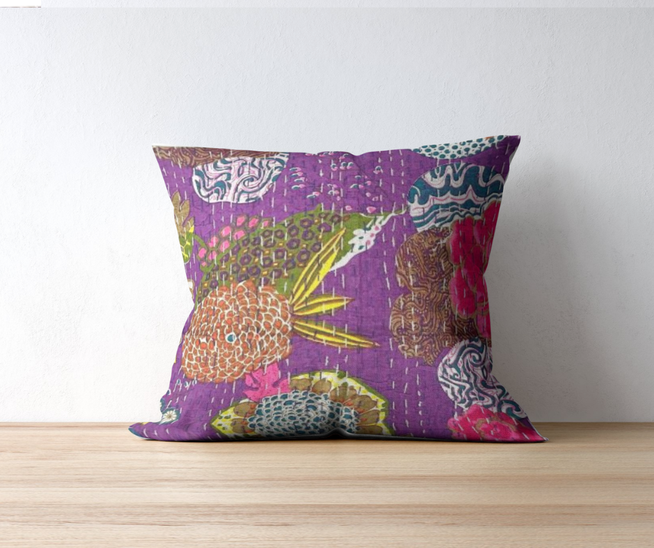 Hand-stitched Kantha throw pillow with vibrant floral patterns on purple cotton voile cover, reversible solid backing, handmade in India.